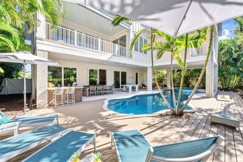 Step into sunlit luxury and feel instant calm beside your private heated pool framed by shimmering canal views.