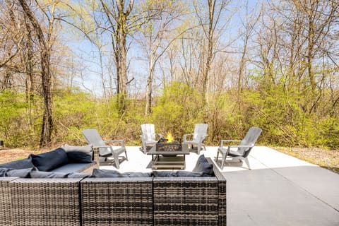 Patio with grill, firepit, and views of the woods