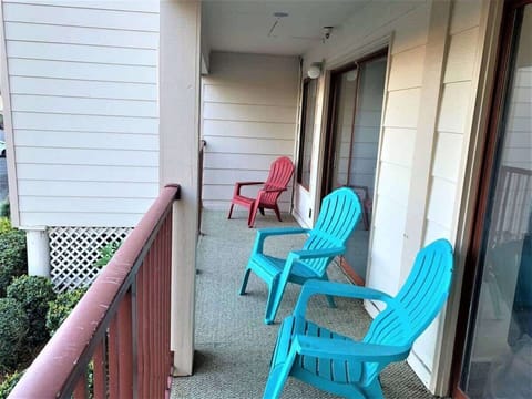 Relax on your personal balcony featuring colorful Adirondack chairs.