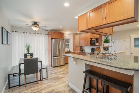 Versatile dining setup for lively meals, with benches, chairs, and counter stools.