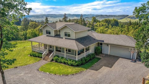 Spacious 4BR retreat with vineyard views, wraparound porch, hot tub, fenced yard & room for unforgettable family escapes.