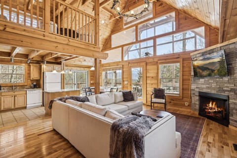 Cozy up in this spacious living room! Soaring vaulted ceilings with fireplace.