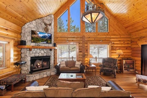 Spacious living room with vaulted wood ceilings and 2 story rock fireplace. Plenty of seating and light. 