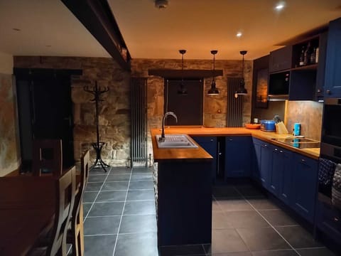 Exposed natural stone on inside of front wall and in alcove by the door