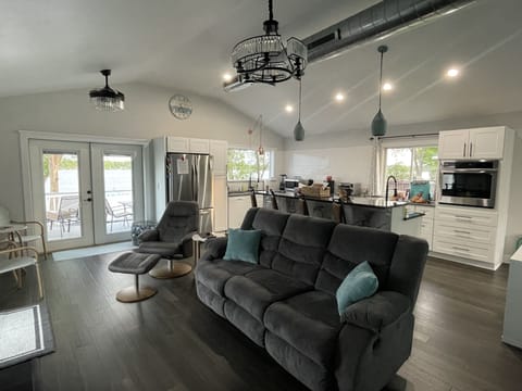 Open concept living room with patio door leading to deck 