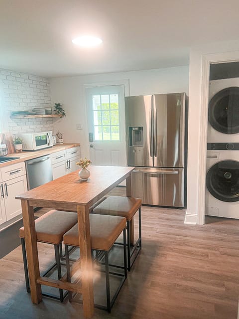 New stainless steel appliances in the kitchen and a washer and dryer