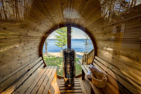 Unwind in the cedar barrel sauna with unobstructed lake views right through the porthole window.