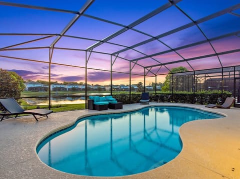 Screened-in pool glowing at sunset, ideal for relaxed evening swims.