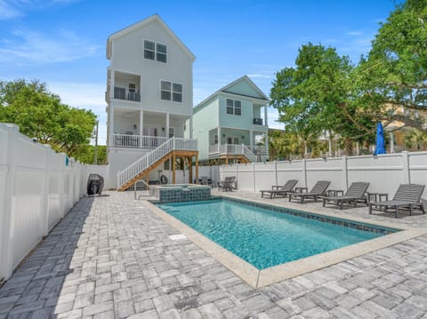 Charming beach houses with private pool area featuring lounge chairs and spa, surrounded by tropical landscaping for ultimate relaxation.