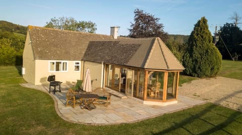 Private patio area with table benches and furniture. Charcoal BBQ.