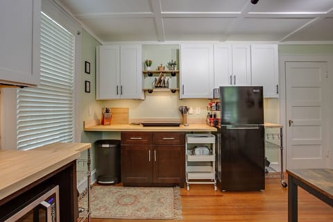 Large, modern kitchen with undercabinet lighting, cookware, olive oil & spices
