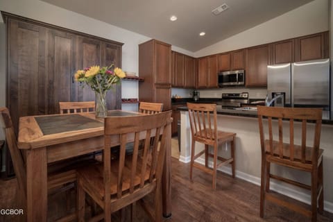 View of dining, murphy bed, and upgraded kitchen.