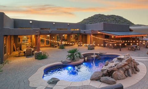 This backyard oasis features this refreshing pool and outdoor kitchen area.