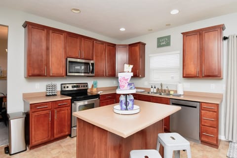 This modern kitchen boasts stainless steel appliances and granite countertops, ideal for preparing meals.