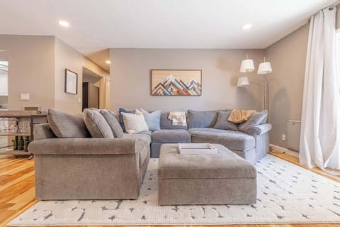 Living room with recessed lighting on dimmer.75 " Smart TV.XL Doggie door.Bar cart with glasses.