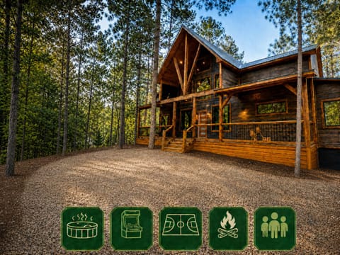 This beautiful cabin nestled in the woods features a striking modern design with warm wood tones, expansive windows, and a welcoming deck—the perfect peaceful retreat surrounded by towering pines.