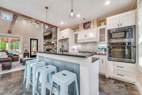 Spacious cabin kitchen with bar seating and farmhouse dining table