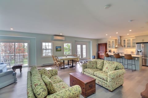 Spry 4 living, dining, and kitchen opening to a large balcony and view to the water