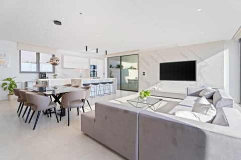 Living room offers a comfortable sofa with a flat-screen TV, PlayStation 5, Bluetooth speakers, a Netflix, Spotify, and more.