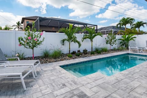 Outdoor Oasis: Dive into relaxation by the sparkling pool surrounded by tropical beauty!