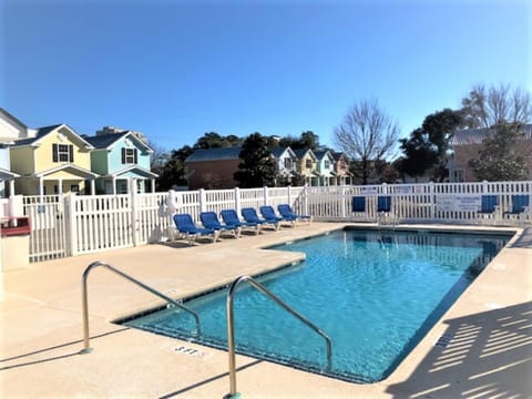 Outdoor pool area with clear skies and plenty of seating