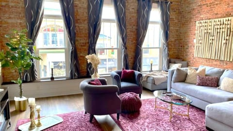 Spacious yet cozy: settle in beneath 12-foot ceilings, exposed brick, and tall windows over downtown.