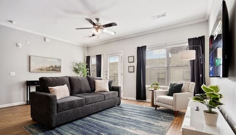 Open and large living room with sleeper sofa and smart tv