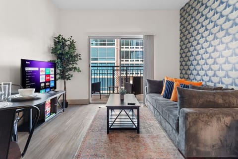 Unwind in the cozy living area complete with a comfy sofa, 50-inch TV & cute dining table!