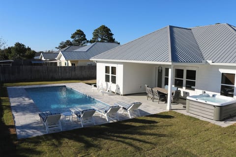 Beautiful backyard featuring a salt-water pool, hot tub, playground & patio