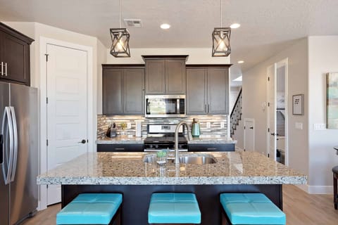 Kitchen Area - The Kitchen is complete with everything you will need for meal preparations including pots, pans, baking dishes, plates, cups, silverware, cutlery, and an assortment of cooking utensils.