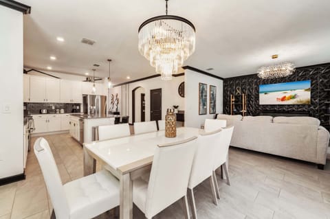 Elegant dining and living space with modern kitchen, perfect for entertaining large groups in style.
