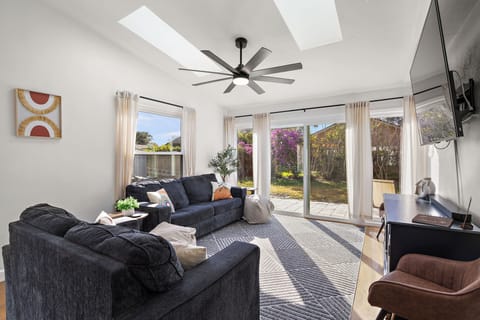 Spacious living room with natural light pouring in through every window.