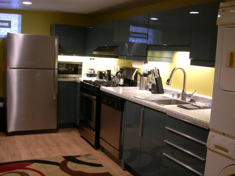 Stainless Steel refrigerator with ice maker, microwave, gas range & dishwaasher.