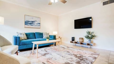 Airy living space complete with a sleep sofa and smart TV.
