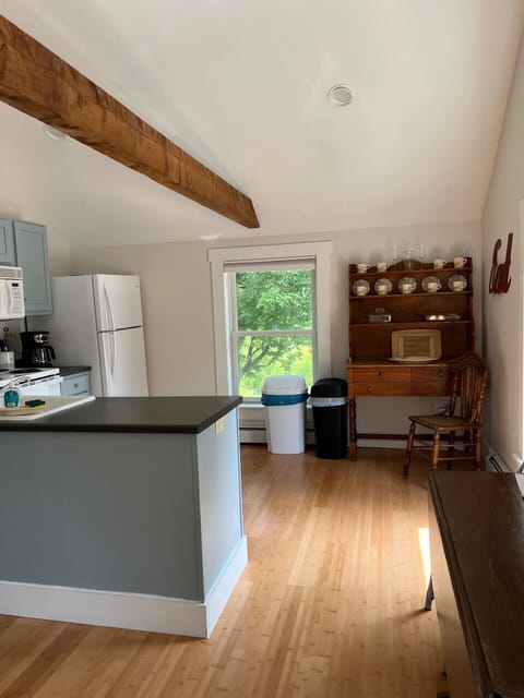 Kitchen with 4 burner range, refrigerator, microwave, and dishwasher. 
