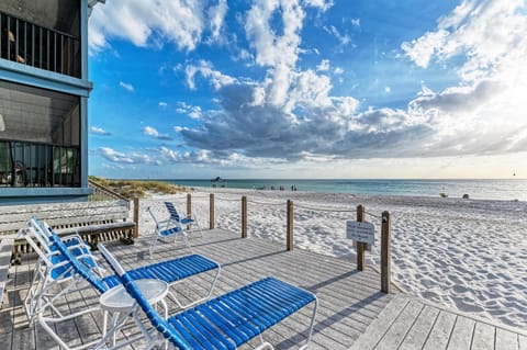 View from tanning deck overlooking the beach with lounge chairs in the sun