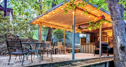 Outdoor bar & grill, refrigerator, sink with granite countertops.