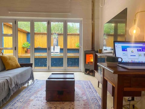 A cozy space to catch up on some work: nestled in front of the fireplace. There is a work station / desk located in the open plan lounge for those who work from home or need to get some work done whilst on a getaway. 