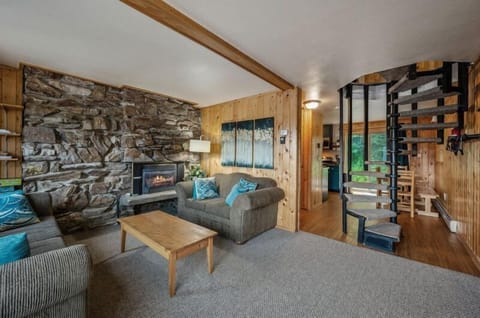 Main living space that flows into kitchen and eating nook. With spiral staircase to second floor.