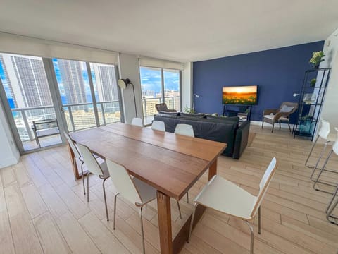 Bright living room with balcony access and city views.