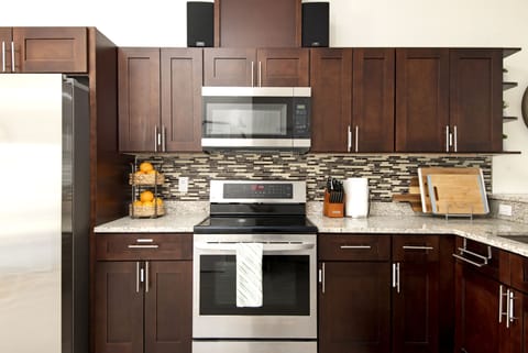 Fully stocked oils, cooking and baking ingredients, pots and pans, plates