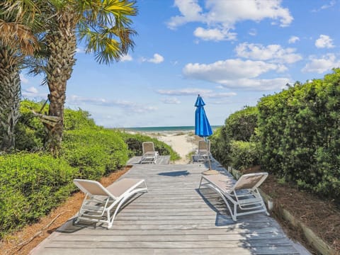 Private boardwalk to the beach with oceanfront lounging.