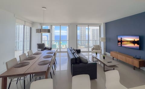 Bright living room with balcony access and city views.