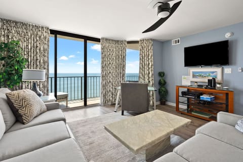 Living area with sliding doors to the oceanfront balcony at Beach Club 2 9B, a 3-bedroom condo from Thomas Beach Vacations