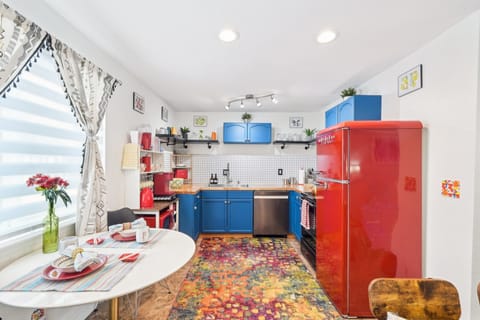 The vibrant retro kitchen is fully equipped for cooking at home.