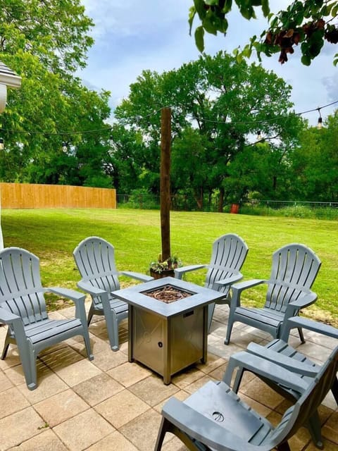 Step outside to a charming back patio with comfortable seating, perfect for sipping morning coffee or unwinding under the stars.