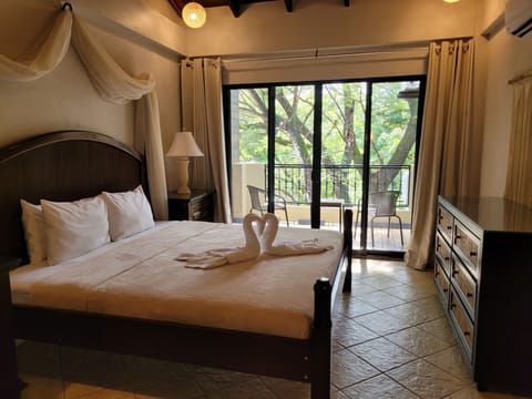 Main bedroom with private balcony and king size bed