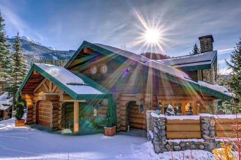- Snow-dusted log cabin with ski-in ski-out trail and pine forest views  
- Morning sun shines over wood beams for a warm alpine welcome  
- Perfect Whistler getaway surrounded by mountain serenity  
