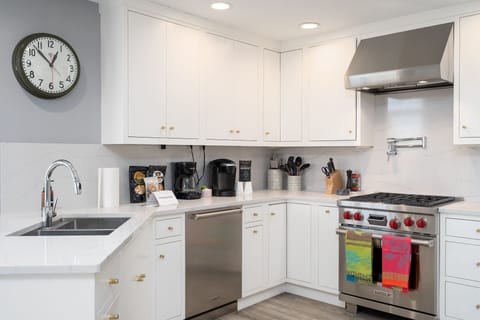 Cook your favorite meals in this bright, modern kitchen with premium appliances and coffee maker for perfect mornings.