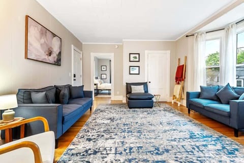 Plenty of seating in this light-filled space with large front-facing windows and a spacious layout for relaxing or gathering.